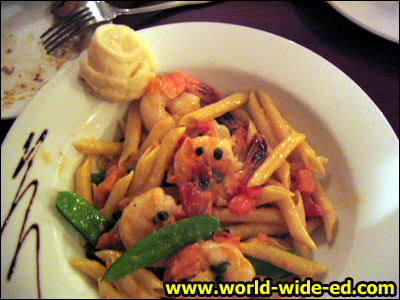 Sauteed Shrimp with Penne Pasta - A garlic white wine broth garnished with capers and tomatoes for $21