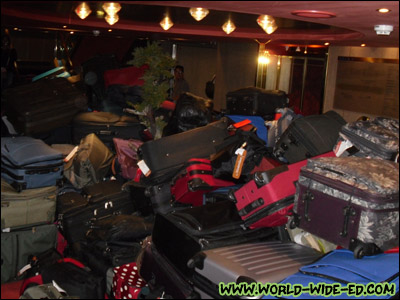 Mystery solved: the pile of luggage (ours is in there somewhere) [Photo Credit: Lee Kojima]