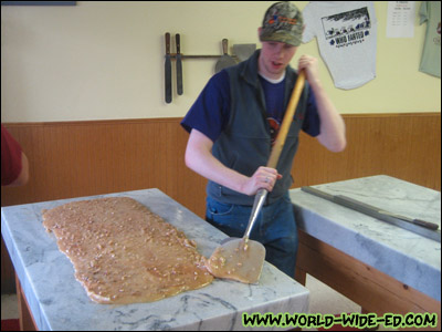 Alaskan Fudge Co. employee making some sweets on a marble slab