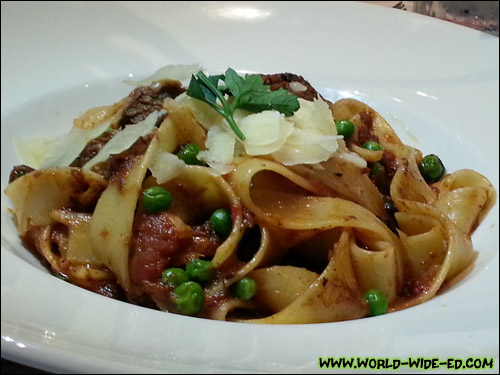Cat's Braised Short Rib Parpadelle with baby peas, rich Napoli sauce and shaved parmesan ($22)