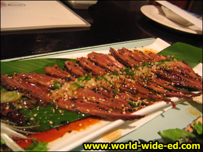 Filet Mignon Beef Sashimi with Garlic & Soy Vinaigrette, $16 - This is the prized dish of Osake. Quickly seared with herbs and spices, then cut sashimi style. Drizzled with their famous soy vinaigrette and garlic. Served with organic greens