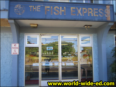 Sign outside The Fish Express (and some goon's reflection)
