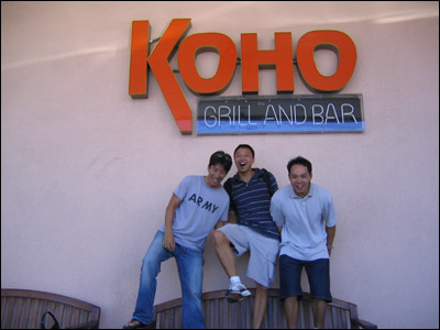 Having a little too much fun in front of the Koho Grill and Bar sign