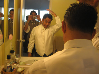 Dicson putting the finishing touches on the 'do with his stalker/paparazzi capturing the moment.