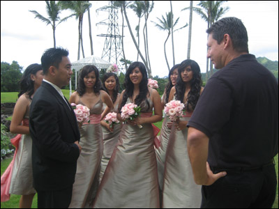 Dics giving last minute instructions to the videographer while the bridesmaids look on.