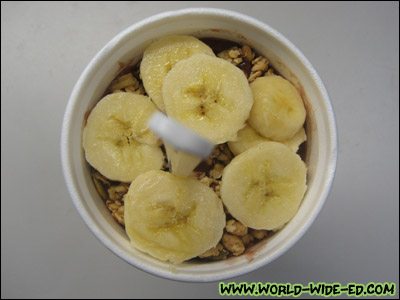 Açai Cup topped with fresh bananas (Brazilian Açai juice, soymilk, strawberries, blueberries, bananas, also topped with organic granola) - $5.25 for the sixteen ounce / $6.25 for the original size