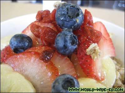 Close-up of Deluxe Açai Bowl toppings (strawberries, blueberries, Goji berries and bananas)