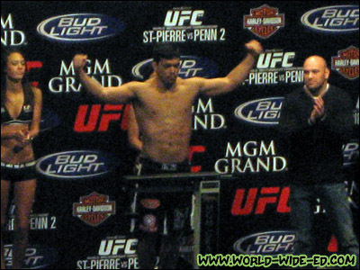 Lyoto Machida comes in at 206 as ring girls Logan Stanton and Arianny Celeste, and UFC President Dana White look on.