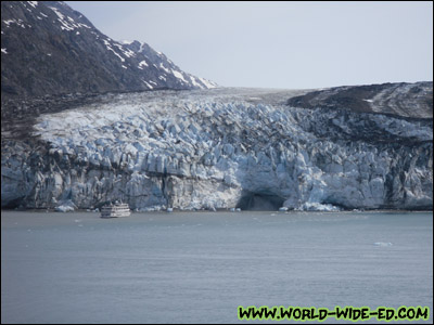 Glacier near Glacier Bay (notice the relative size of the ship in the water and the gushing waterfall in the cave?) [Photo Credit: Lee Kojima]