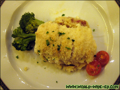 Halibut Caddy Ganty entrée - Topped with sour cream, onion and fresh breadcrumbs, served over olive oil red-skin mashed potatoes, broccoli florets and roasted cherry tomatoes.