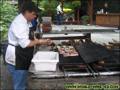 One of the chefs prepping the salmon to be grilled