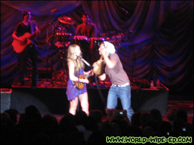 Colbie Caillat with her ukulele battling Justin Young on stage