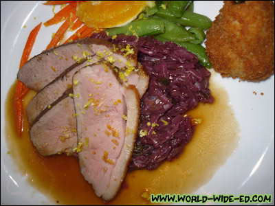 Duck Breast a l'Orange - The old-time favorite, oven roasted until crisp and served with a Grand Marriner sauce, braised red cabbage, pea pods, carrots julienne and William potato [Photo credit: Lee Kojima]