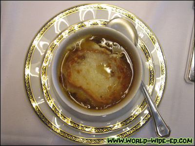 French Onion Soup "Les Halles" - A Parisian classic of golden simmered onions topped with melted Gruyere cheese
