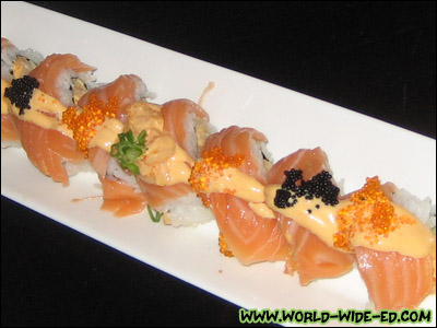 Hottie Roll - spicy scallops, tobiko, cucumber, weapped with salmon - $12