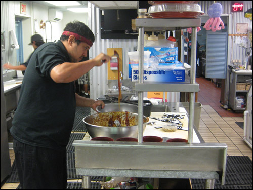 Reno mixing up a batch of Taegu Dry Aku Poke [Photo Credit: Arthur Betts]