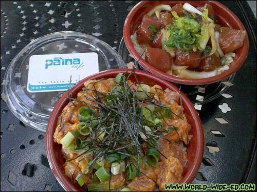 One Small Spicy Tuna Poke Bowl with Shredded Nori, Seaweed Salad and Green Onion on White Rice, and one Small Shoyu Ahi Poke Bowl with Pickled Onions and Seaweed Salad on Brown Rice