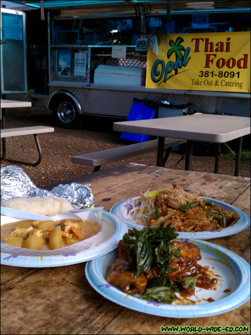 Our Yellow Chicken Curry, Shrimp Pad Thai and Spicy Glaze Garlic Chicken Wings in front of the Opal Thai Food Wagon