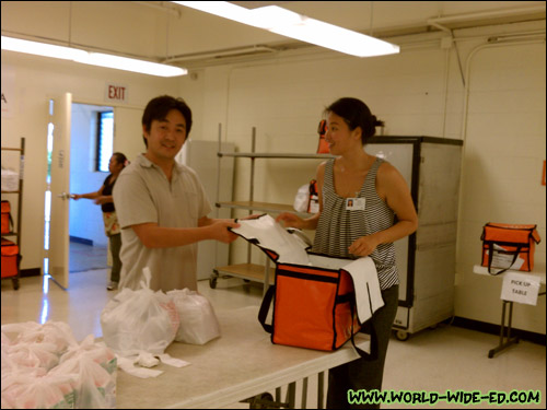 Rick getting help from Randi Jeung to fill his bag.