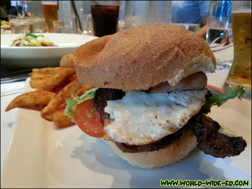 Melissa's Prime Rib Fillet Burger with bacon, egg, lettuce, tomato, caramelized onion, ranch dressing and beer battered fries ($18)