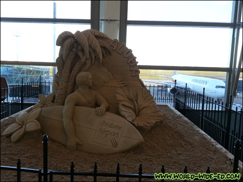 Neat sand sculpture with our Hawaiian Airlines plane in the background