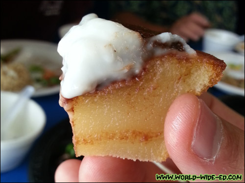 A bite of his wife Doreen's Baked Butter Mochi Cup Topped with Chocolate Ganache and Haupia Pudding ($2.15)